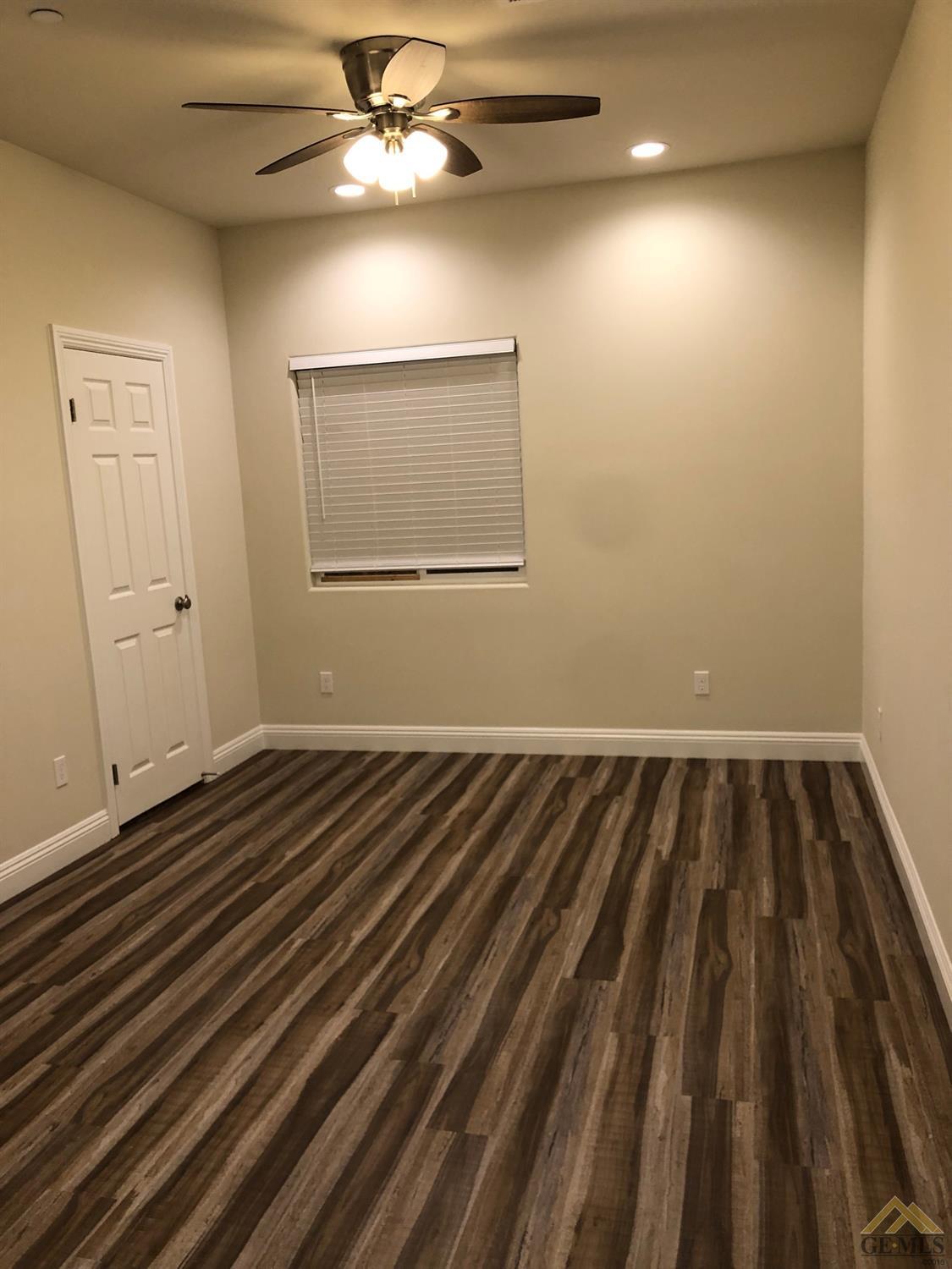 Undisclosed Address Wasco, CA 93280 - Photo 4 of 9 wooden floor in an empty room