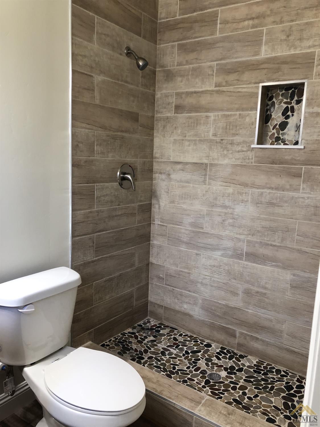 Undisclosed Address Wasco, CA 93280 - Photo 7 of 9 a bathroom with a toilet and a shower