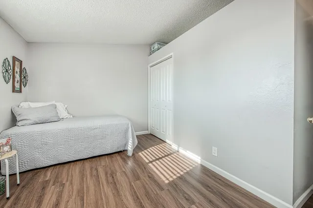 a room with a bed and wooden floor