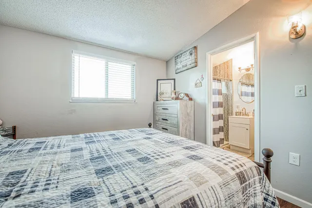 a bedroom with a large bed and a window