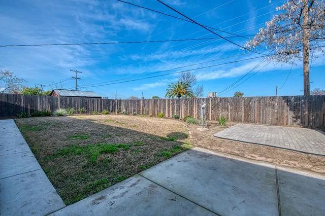 a view of a backyard with wooden fence