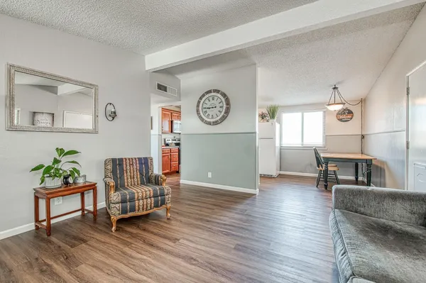 a living room with furniture and a wooden floor