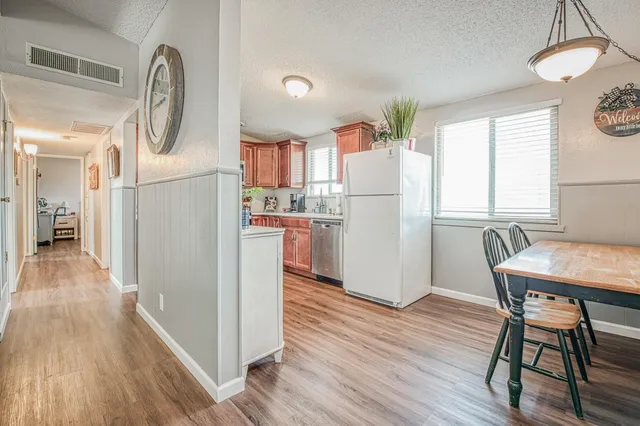 a view of kitchen with furniture and wooden floor