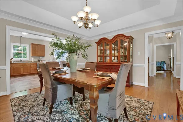 a view of a dining room with furniture and chandelier