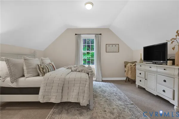 a bedroom with a bed and flat screen tv