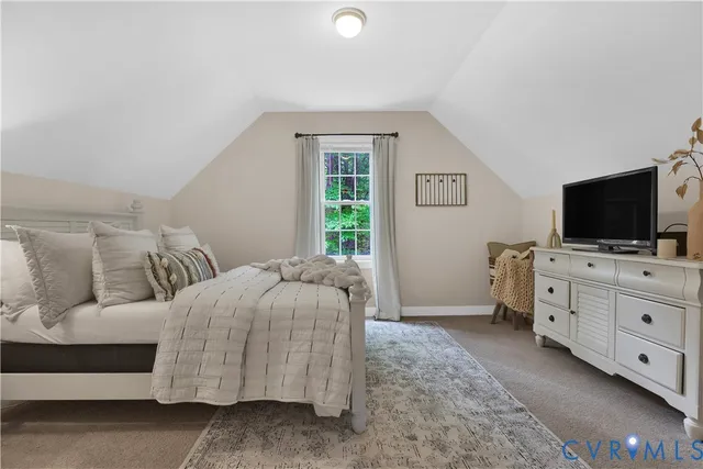 a bedroom with a bed and flat screen tv