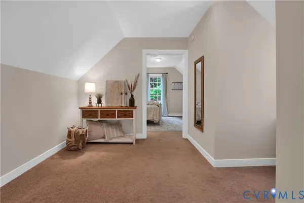 a view of a hallway to a livingroom with furniture and wooden floor