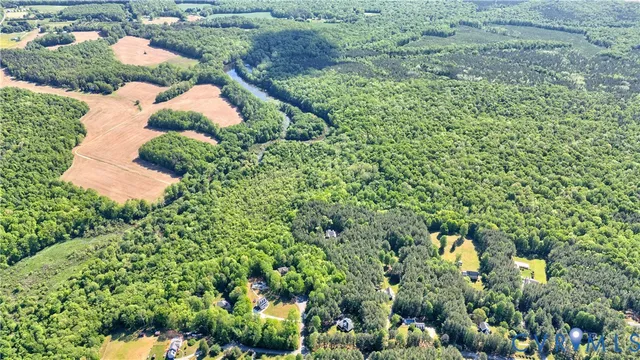 an aerial view of a house with a yard and outdoor seating