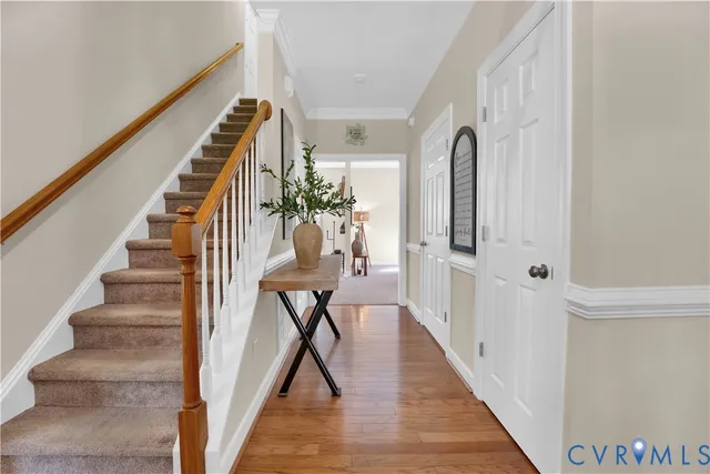 a view of entryway and hall with wooden floor