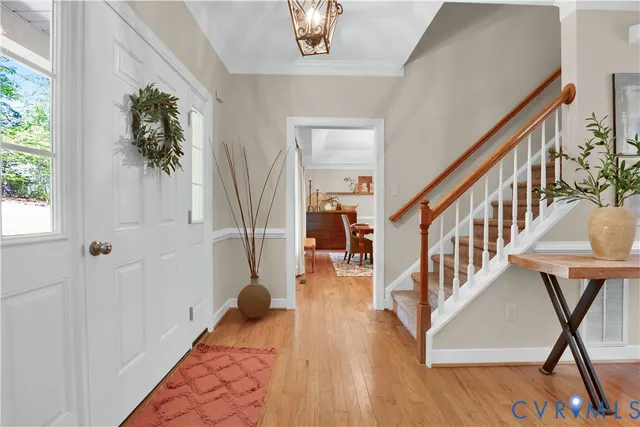 a view of entryway and hall with wooden floor