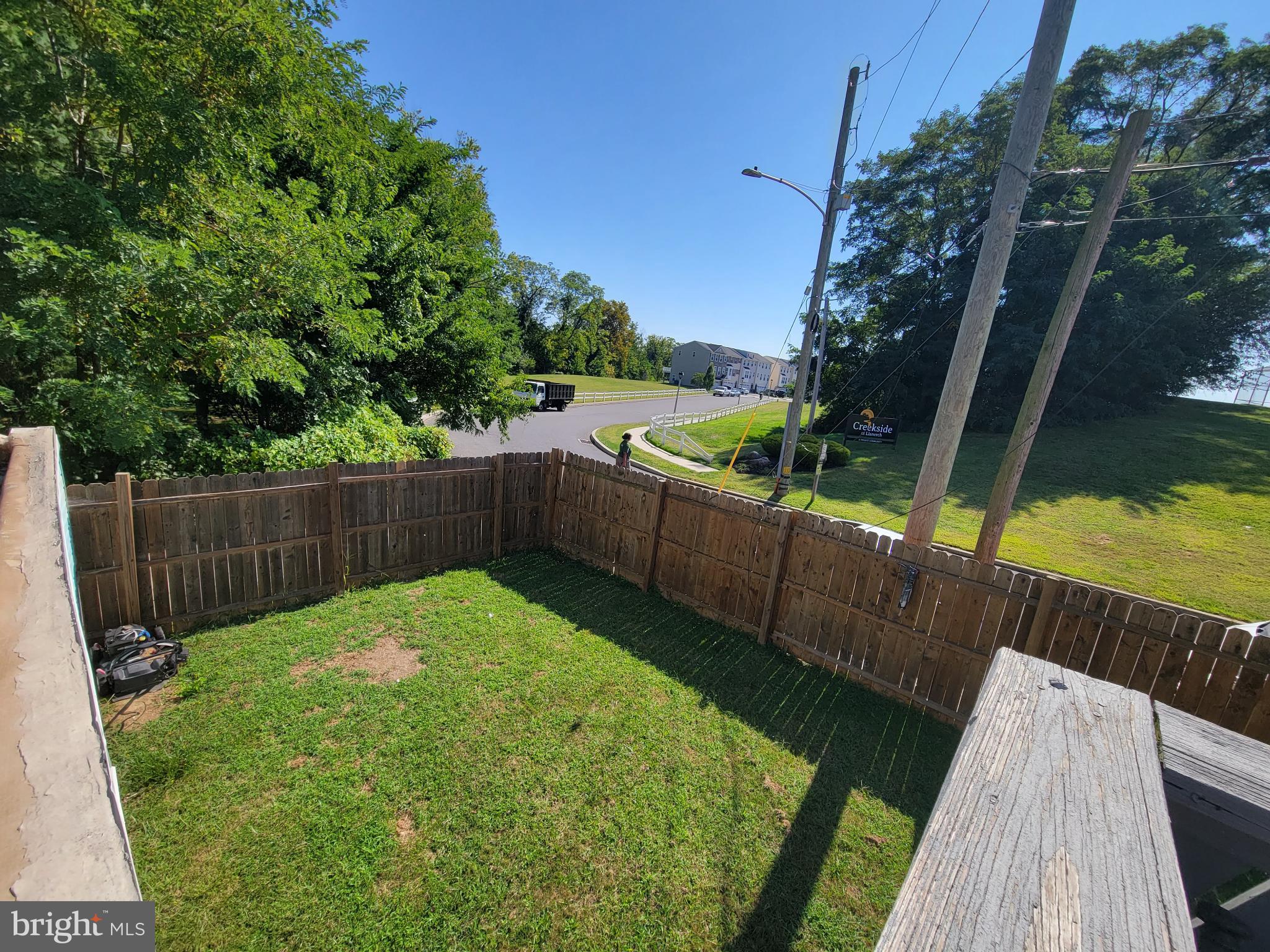 1101 Wilson Drive Havertown, PA 19083 - Photo 7 of 26 a view of a backyard with a garden and wooden fence