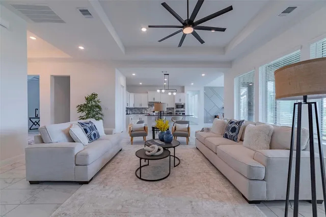 a living room with furniture and kitchen view