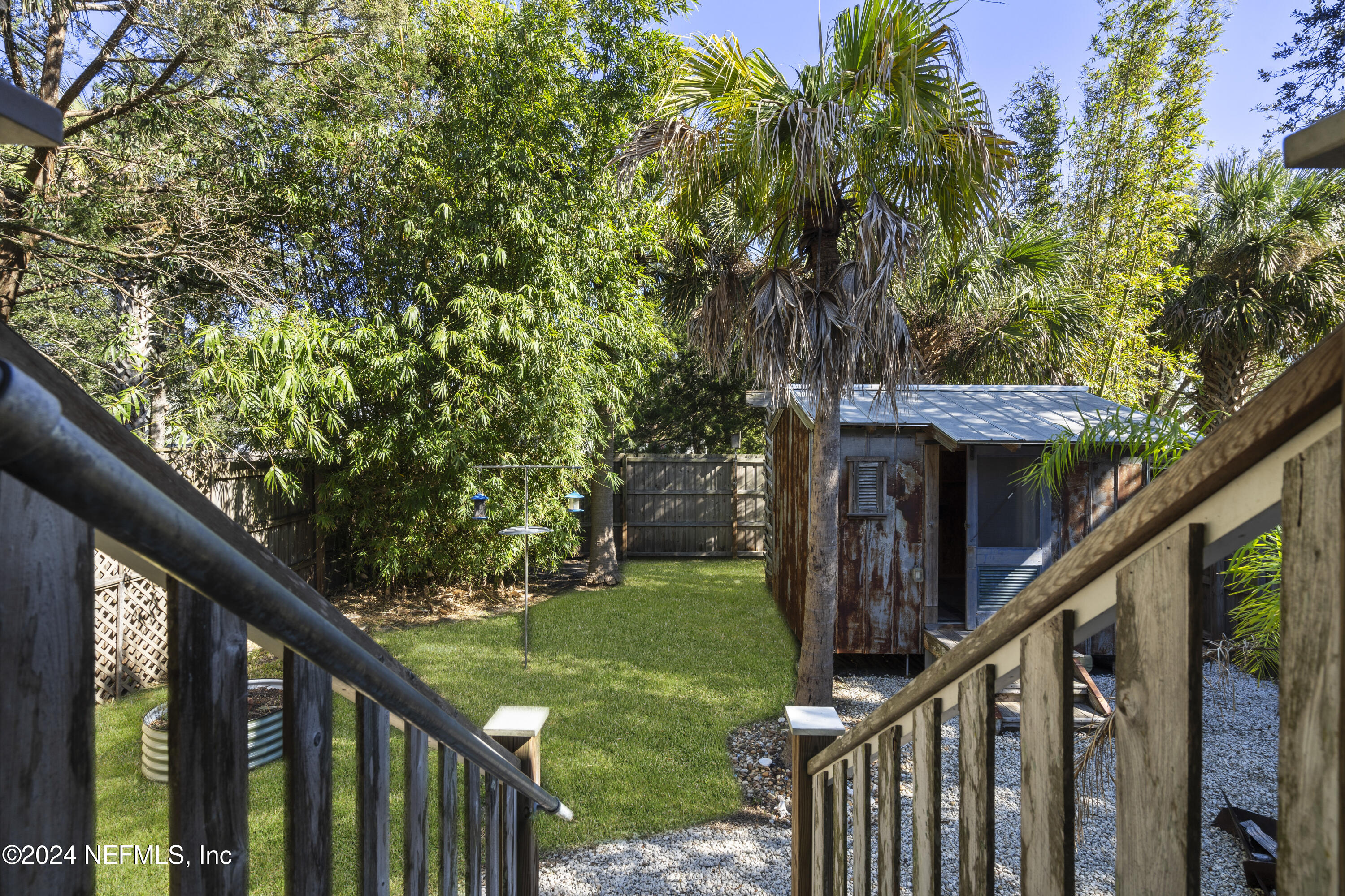 249 Riberia Street St. Augustine, FL 32084 - Photo 26 of 36 a view of a wooden deck and a forest
