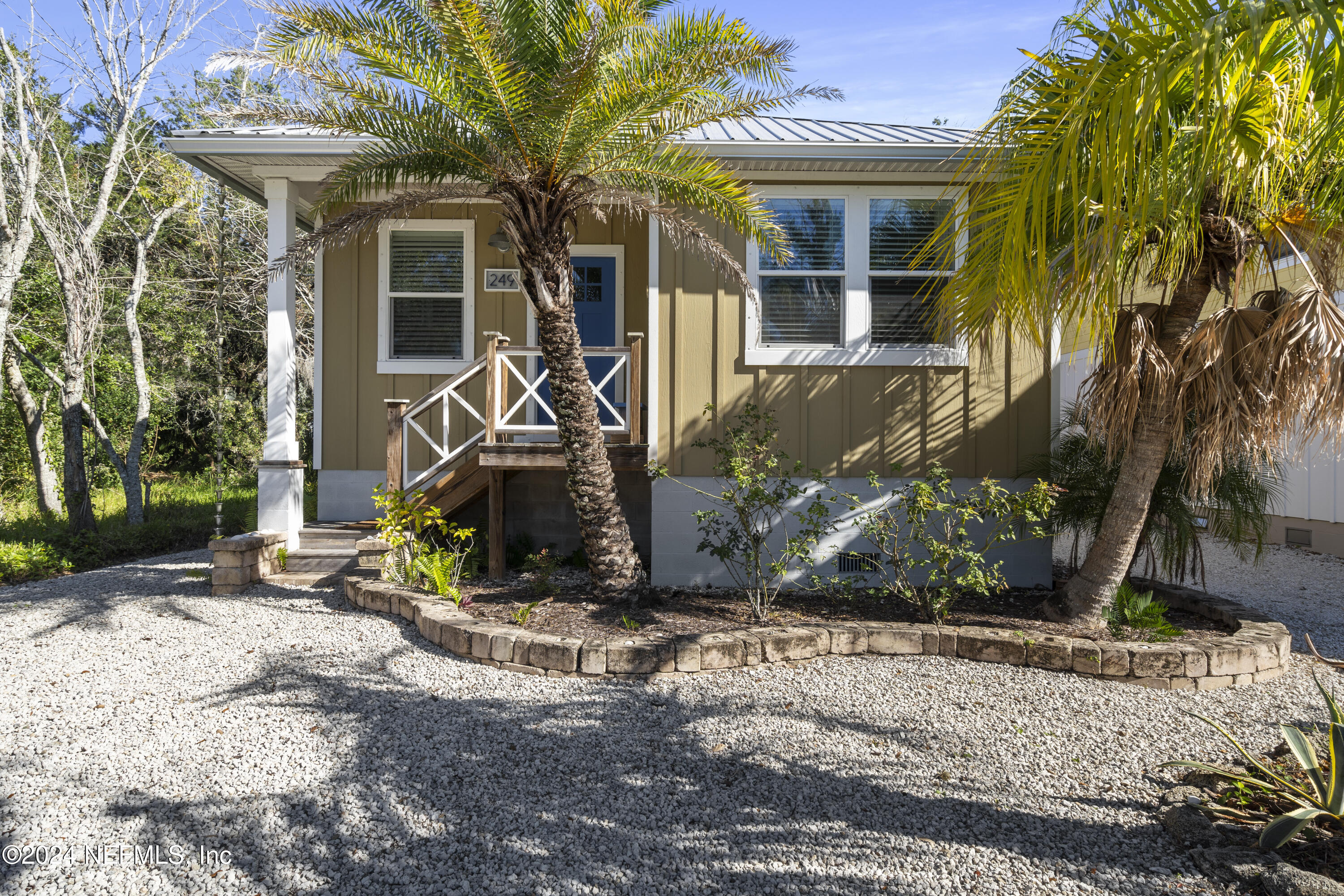 249 Riberia Street St. Augustine, FL 32084 - Photo 6 of 36 a view of a house with potted plants and a large tree