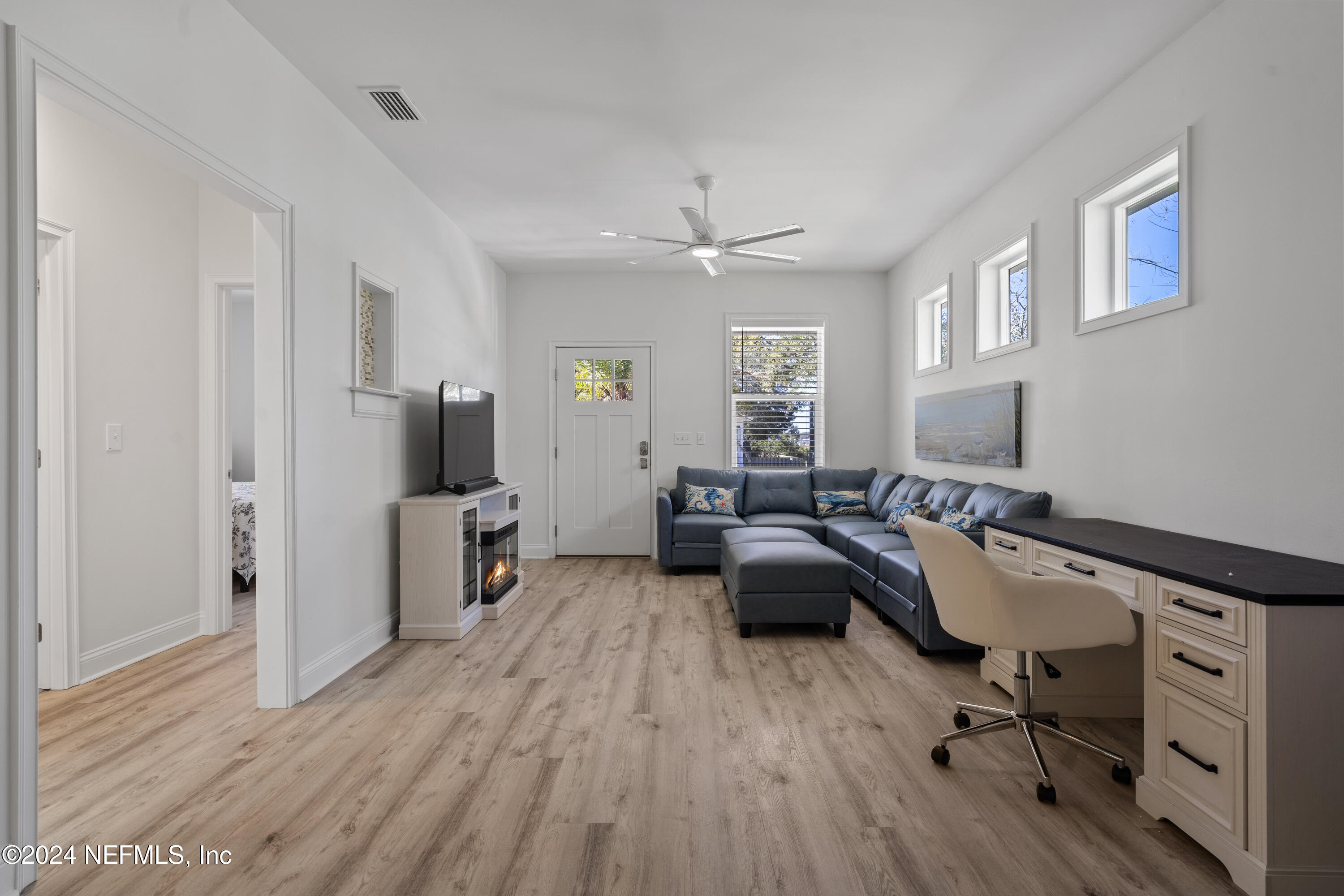249 Riberia Street St. Augustine, FL 32084 - Photo 10 of 36 a living room with furniture flat screen tv and window