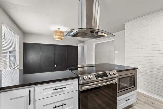 a kitchen with granite countertop a stove and a sink