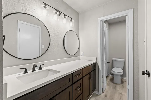 a bathroom with a double vanity sink and a mirror