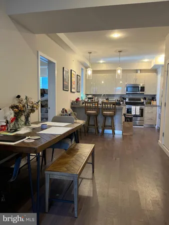 a living room with lots of furniture and a wooden floor