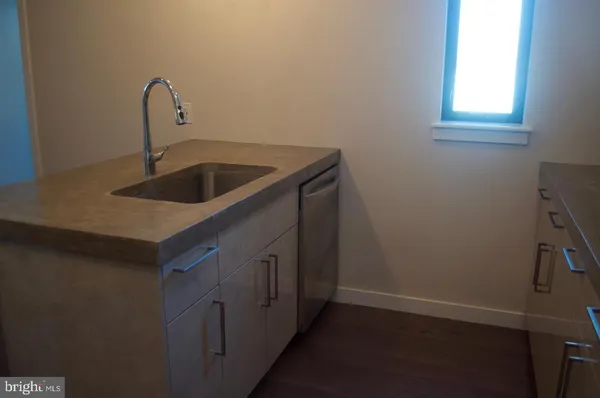 a kitchen with a sink and cabinets