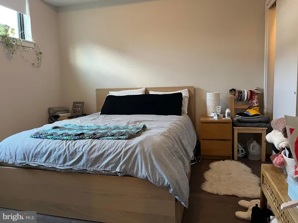 a bedroom with a bed and a dresser