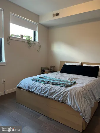 a bedroom with a bed and window