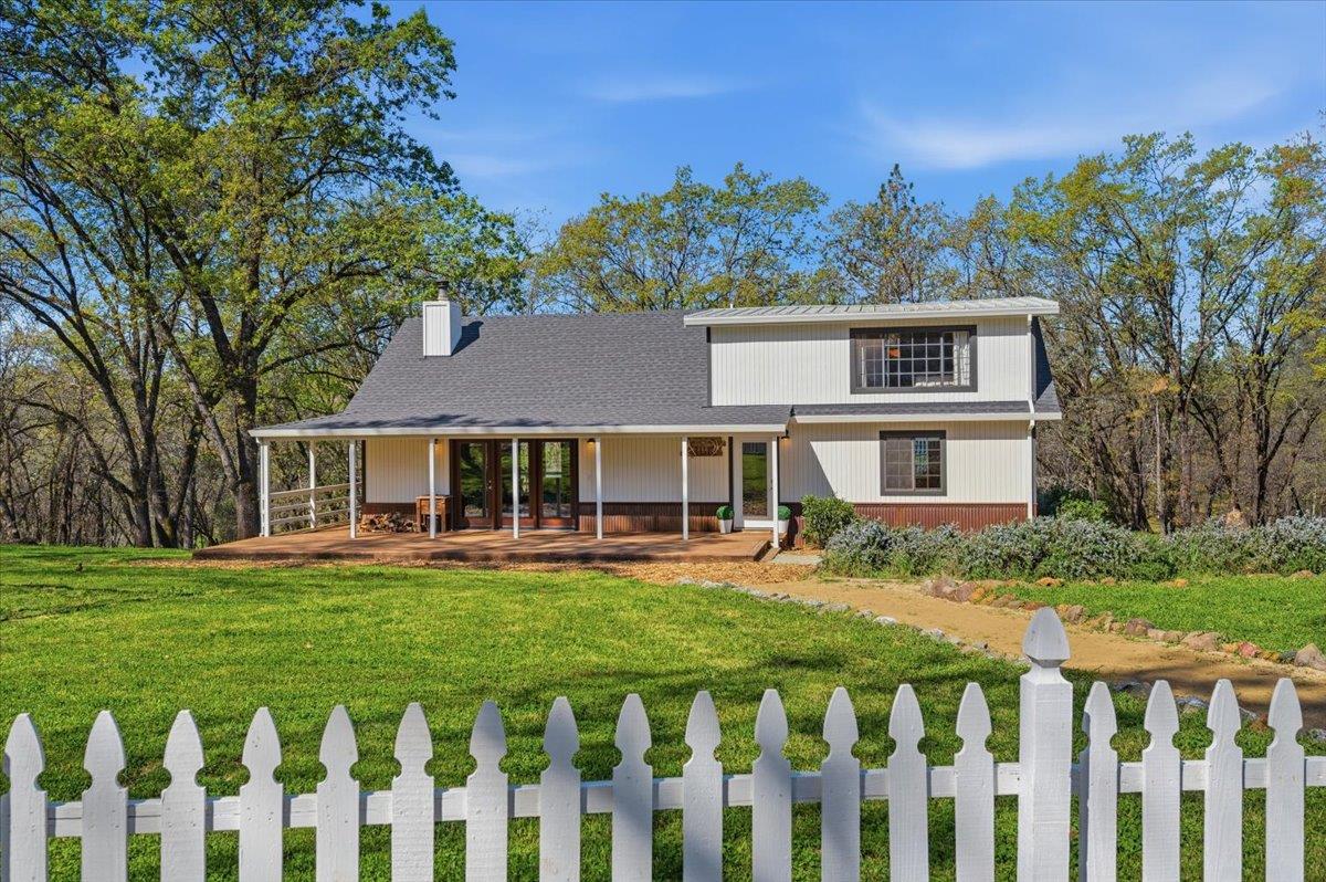 11403 Woodacre Road Grass Valley, CA 95949 - Photo 2 of 69 a front view of a house with a yard table and chairs