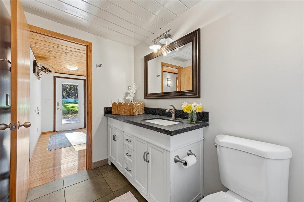 11403 Woodacre Road Grass Valley, CA 95949 - Photo 21 of 69 a bathroom with a toilet sink and mirror