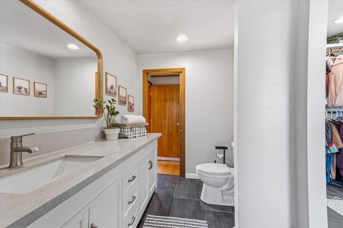 11403 Woodacre Road Grass Valley, CA 95949 - Photo 31 of 69 a bathroom with a double vanity sink toilet and a mirror