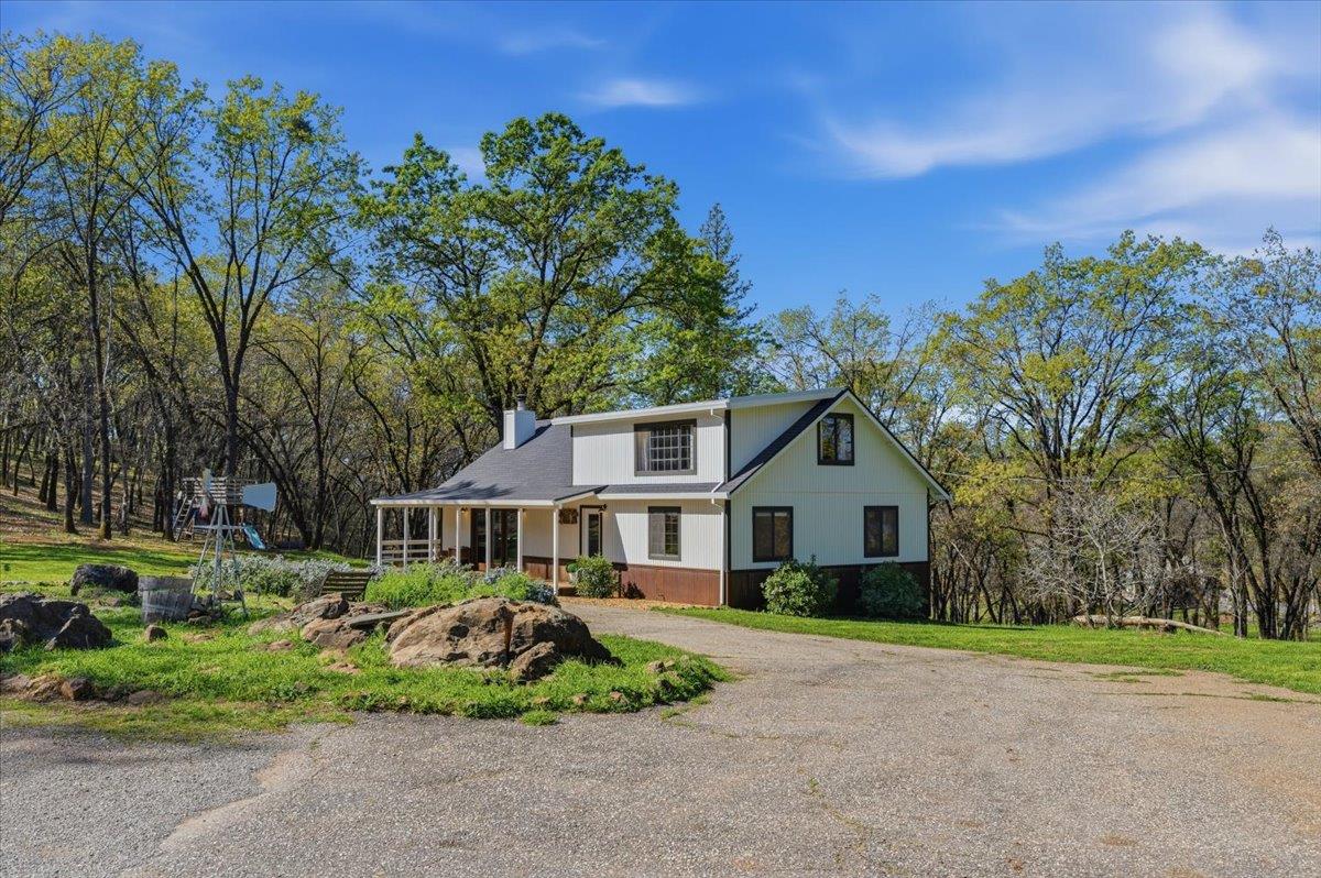 11403 Woodacre Road Grass Valley, CA 95949 - Photo 43 of 69 a front view of a house with a yard and potted plants