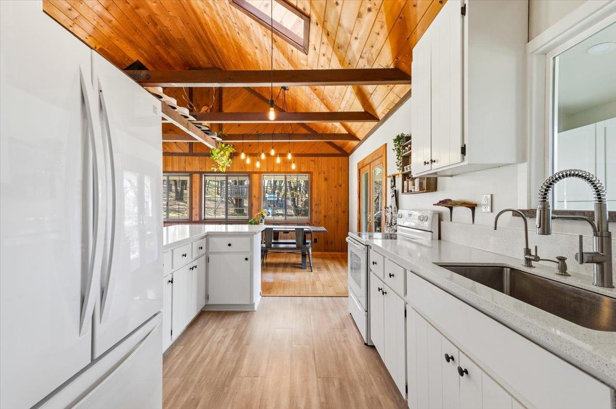 11403 Woodacre Road Grass Valley, CA 95949 - Photo 10 of 69 a kitchen with a stove a sink and a refrigerator