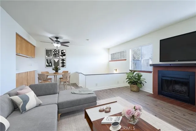 a living room with furniture a flat screen tv and a fireplace