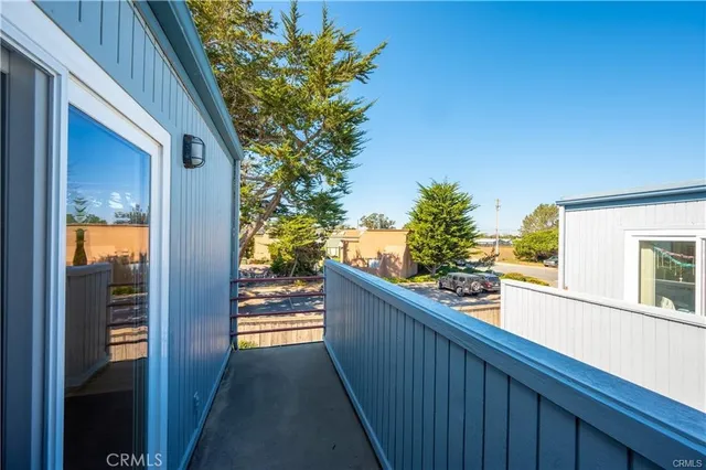 a bedroom with a bed and glass door