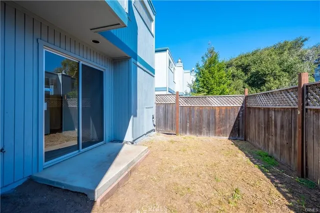 a view of a backyard with wooden fence