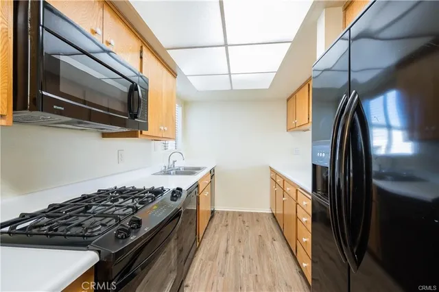 a kitchen with stainless steel appliances granite countertop a stove and a microwave