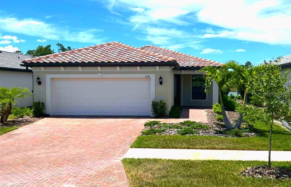 1316 Raspberry Dr Port North Port, FL 34289 - Photo 1 of 1 a front view of a house with a yard