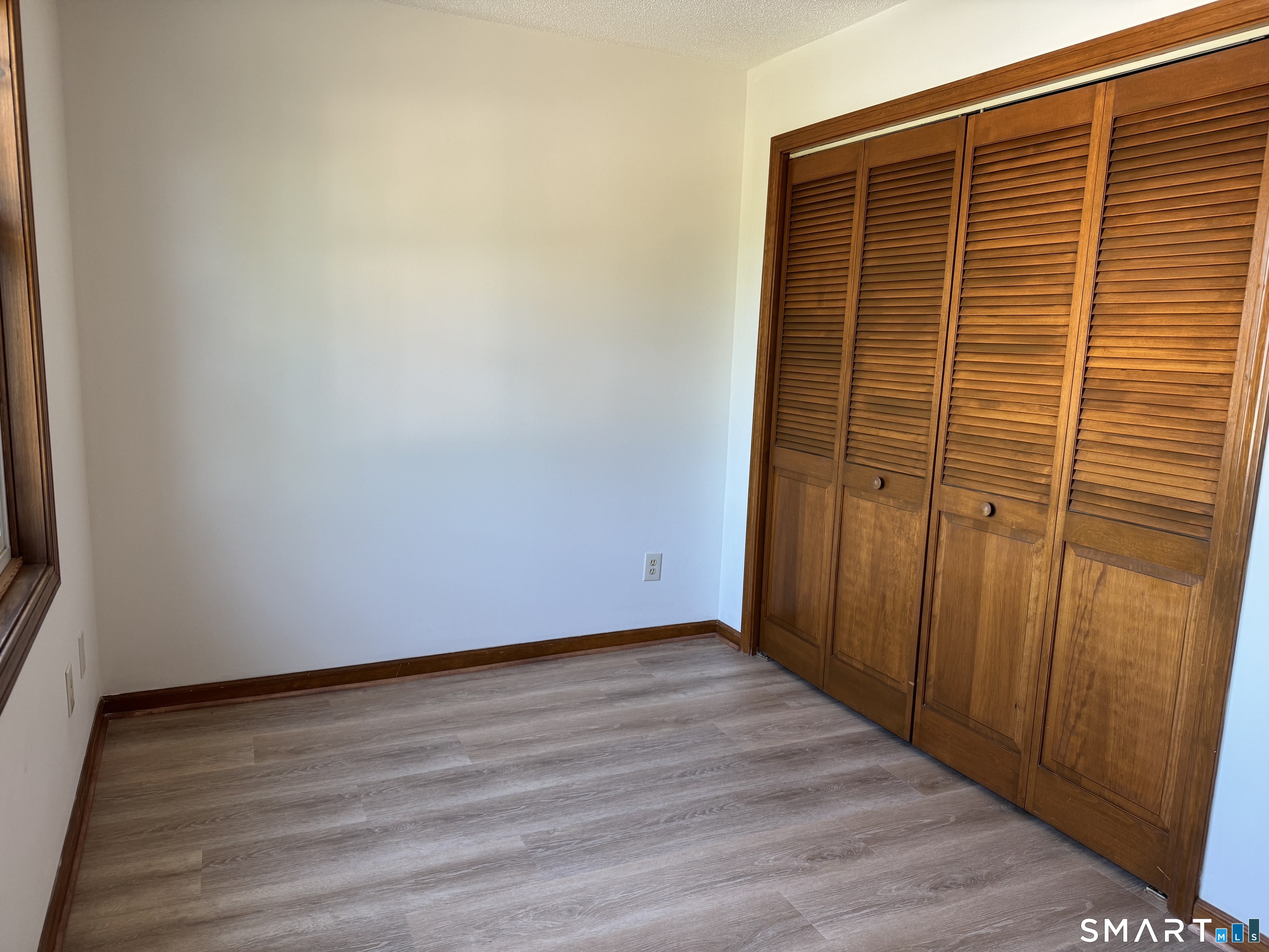 1022 Main Street, Unit 7 Branford, CT 06405 - Photo 7 of 10 a view of an empty room with wooden floor