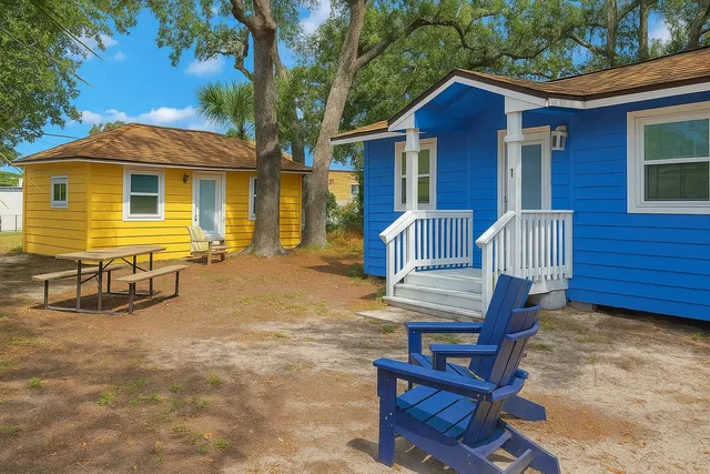 a view of a house with backyard and sitting area