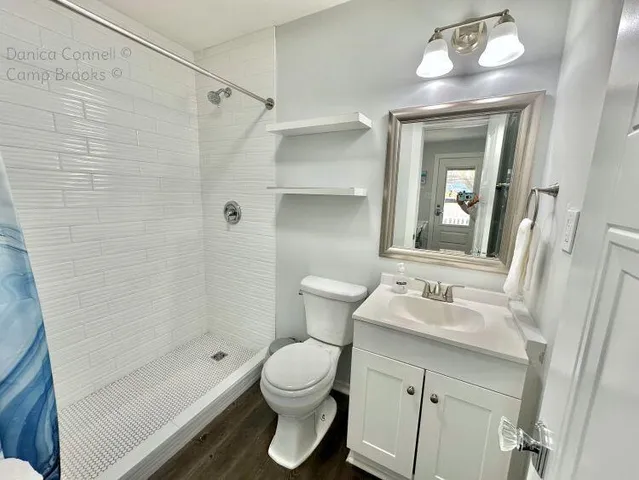 a bathroom with a sink toilet and mirror