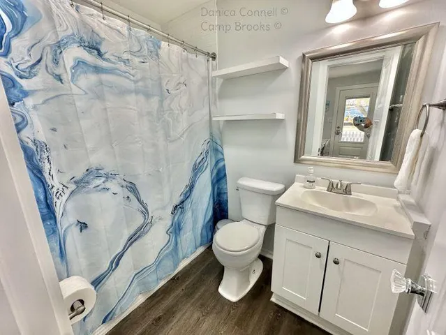 a bathroom with a sink toilet and mirror