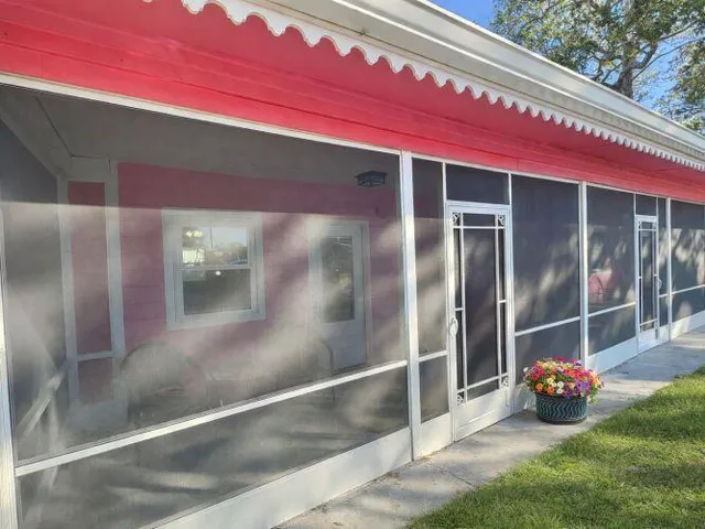 a view of a room with wooden floor