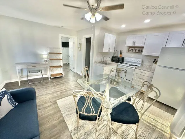 a living room with furniture and kitchen view