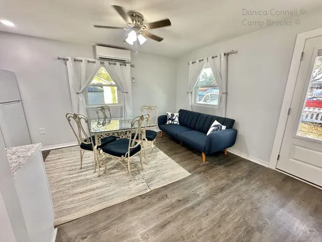a living room with furniture a window and a table