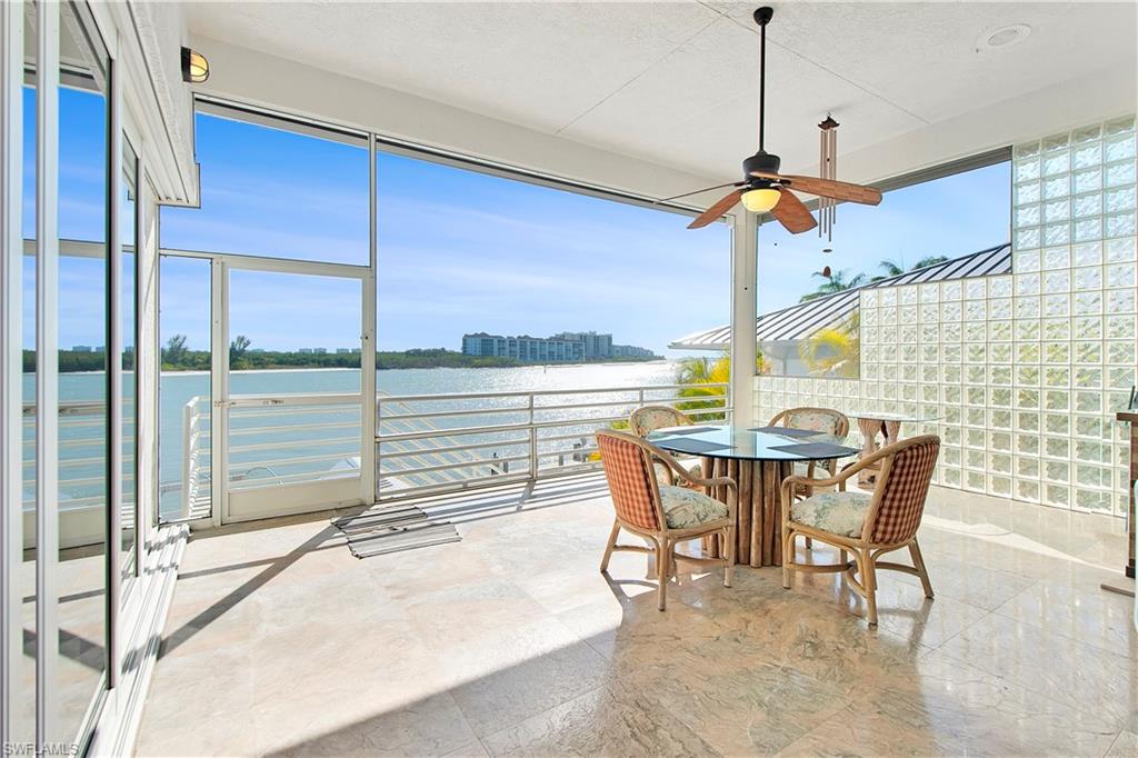28 West Pelican Street Naples, FL 34113 - Photo 14 of 50 a view of a dining room with furniture window and wooden floor