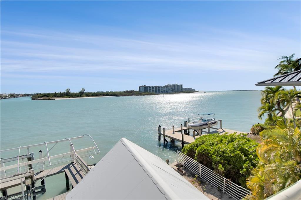 28 West Pelican Street Naples, FL 34113 - Photo 15 of 50 a view of a lake with a terrace