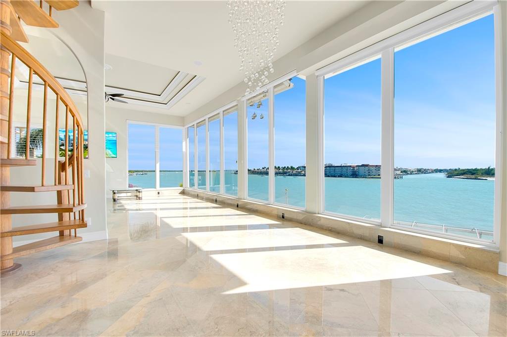 28 West Pelican Street Naples, FL 34113 - Photo 18 of 50 a view of a living room hardwood floor and staircase