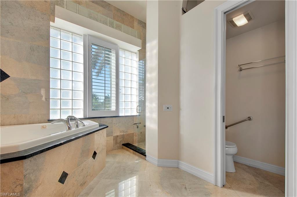 28 West Pelican Street Naples, FL 34113 - Photo 22 of 50 a bathroom with a granite countertop sink and a bathtub