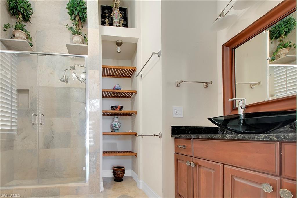 28 West Pelican Street Naples, FL 34113 - Photo 24 of 50 a bathroom with a granite countertop sink and a mirror