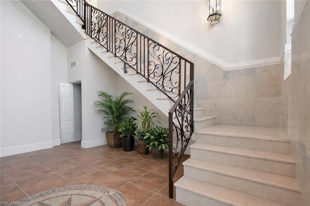 28 West Pelican Street Naples, FL 34113 - Photo 30 of 50 a view of staircase with wooden floor and a potted plant