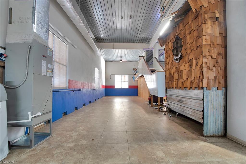 28 West Pelican Street Naples, FL 34113 - Photo 31 of 50 a view of entryway and hall with wooden floor