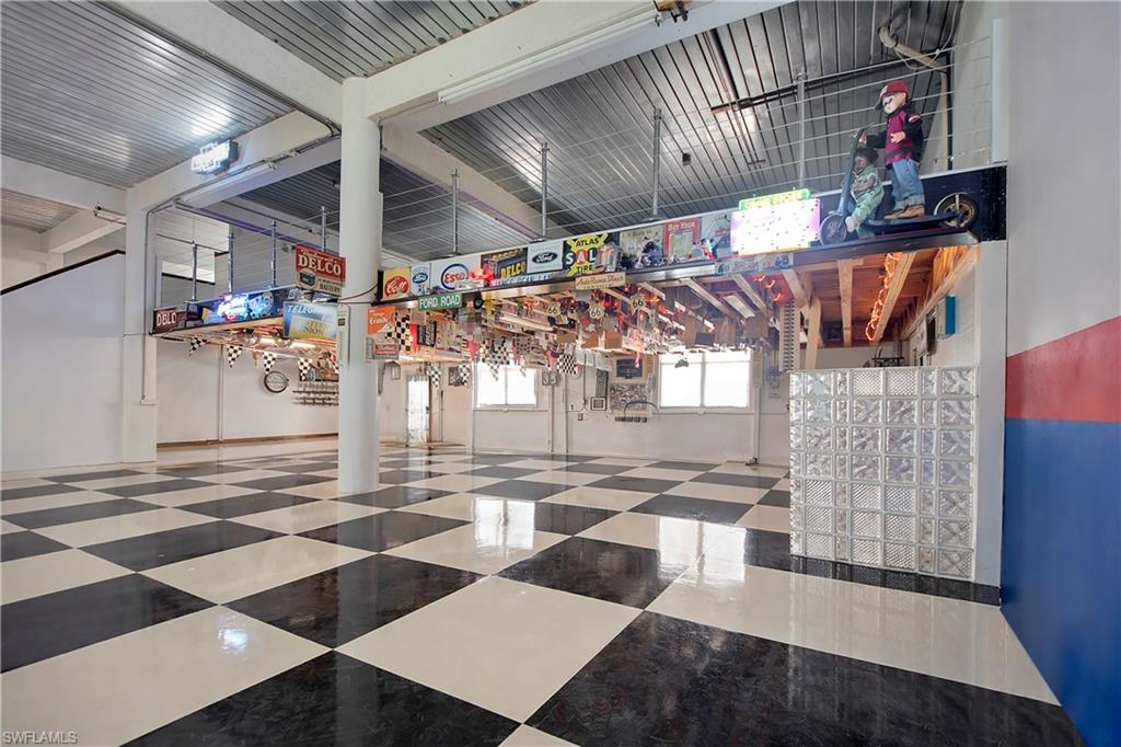 28 West Pelican Street Naples, FL 34113 - Photo 33 of 50 a view of an empty room with wooden floor